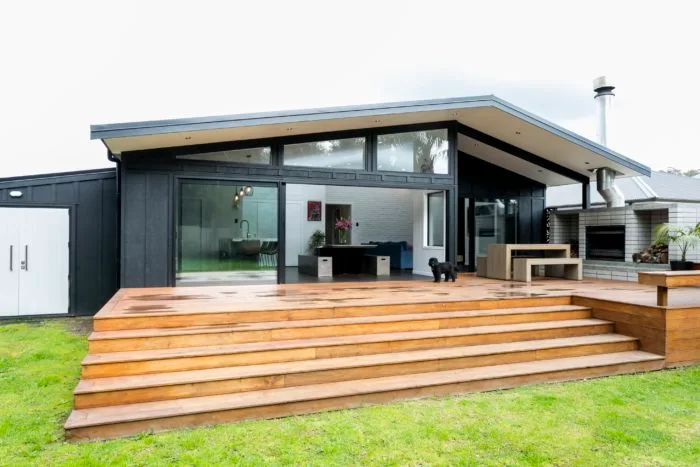 Hazelmere house – rear deck and covered outdoor room opening off the kitchen and living area, dog on the deck