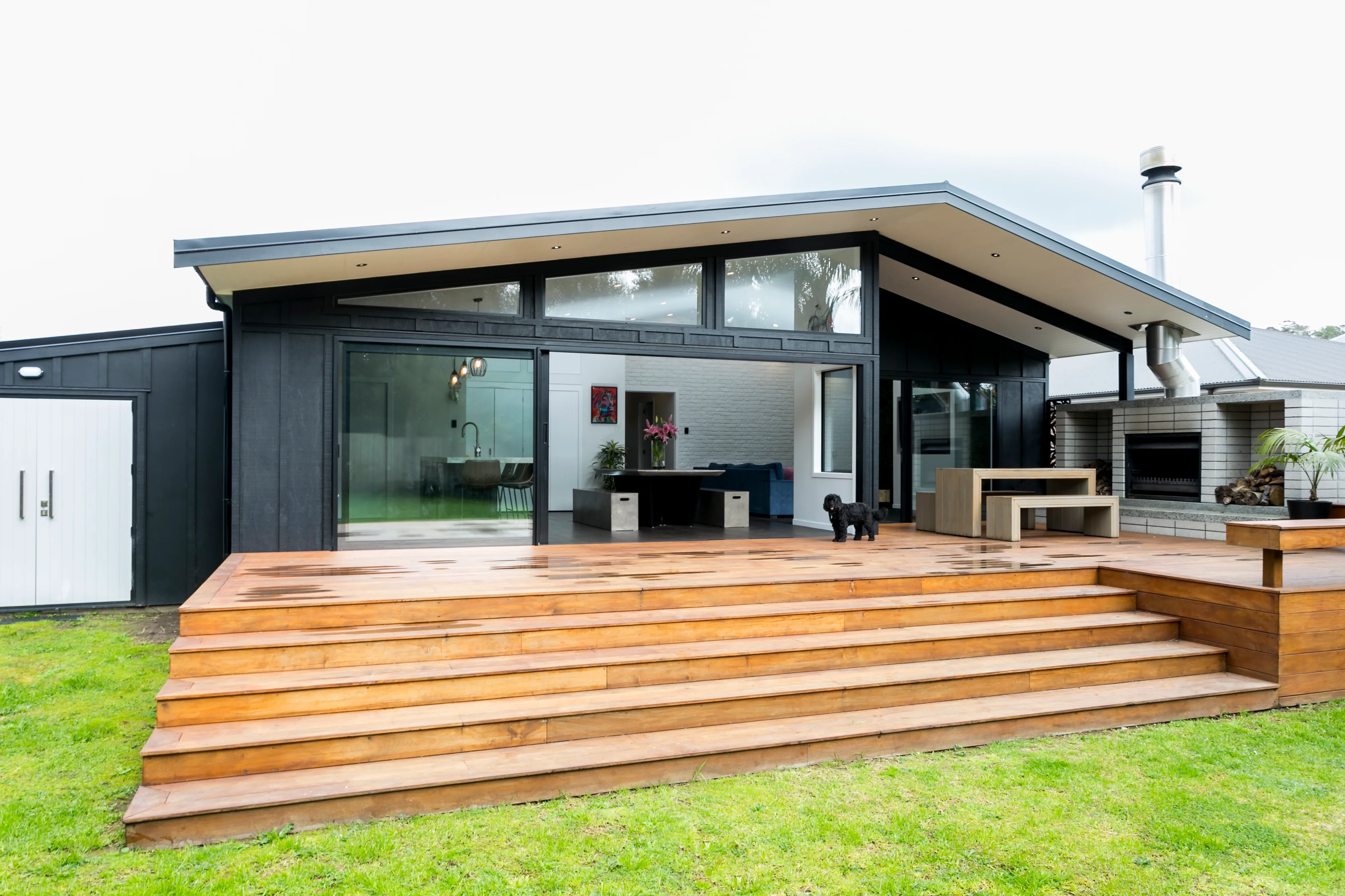 Hazelmere house – rear deck and covered outdoor room opening off the kitchen and living area, dog on the deck