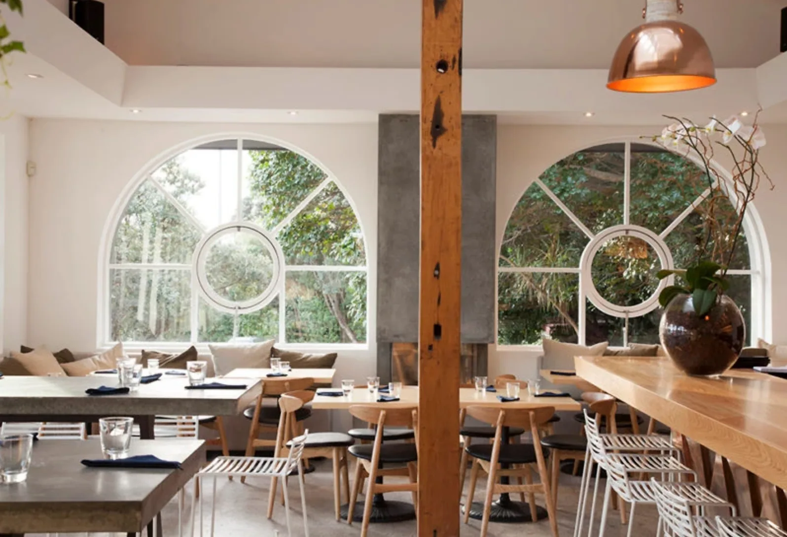 True Food and Yoga – dining room with arched windows either side of a central timber post