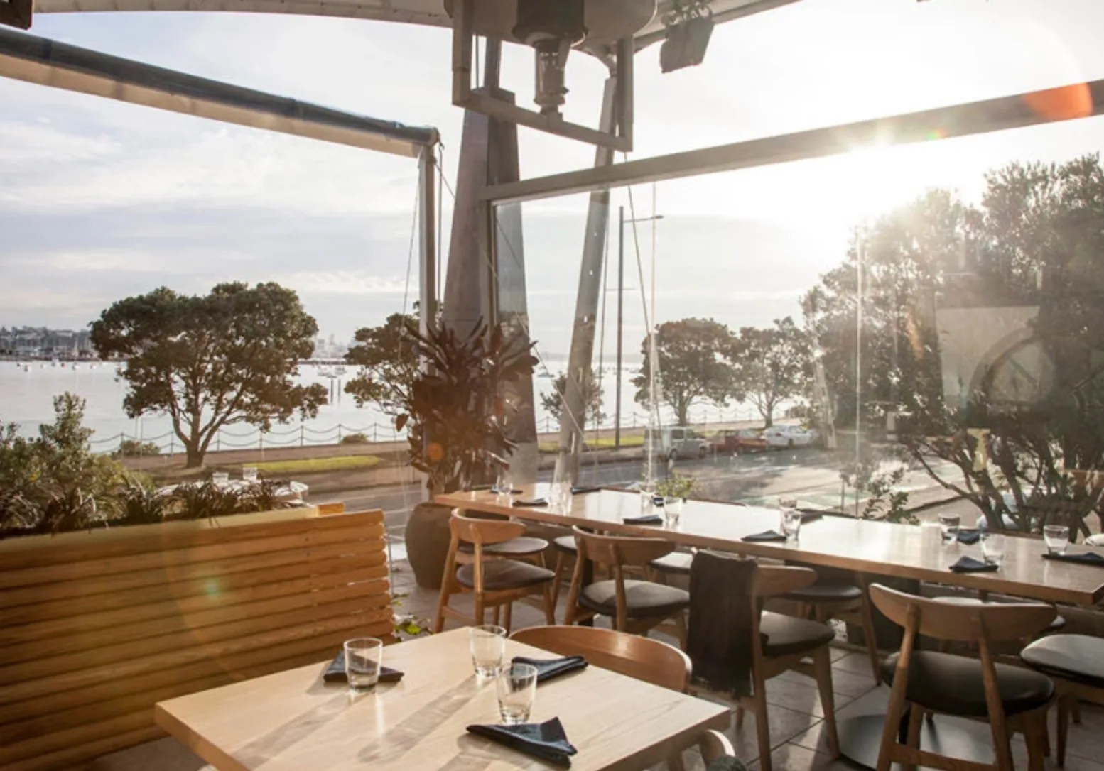 True Food and Yoga – covered deck dining with harbour and boats in view at sunset