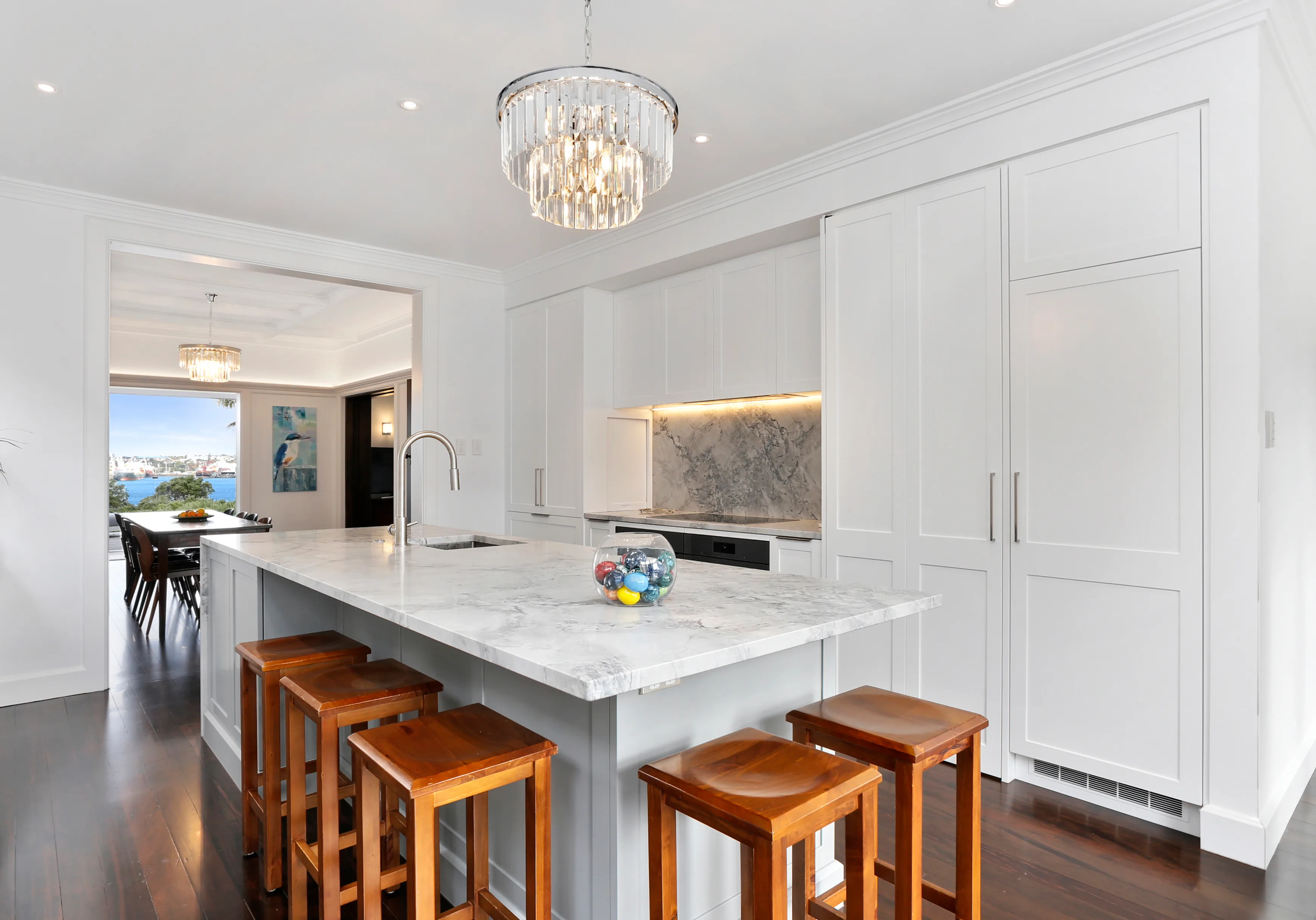 Stanley Point – kitchen island with pendant light, opening to the dining room and harbour view