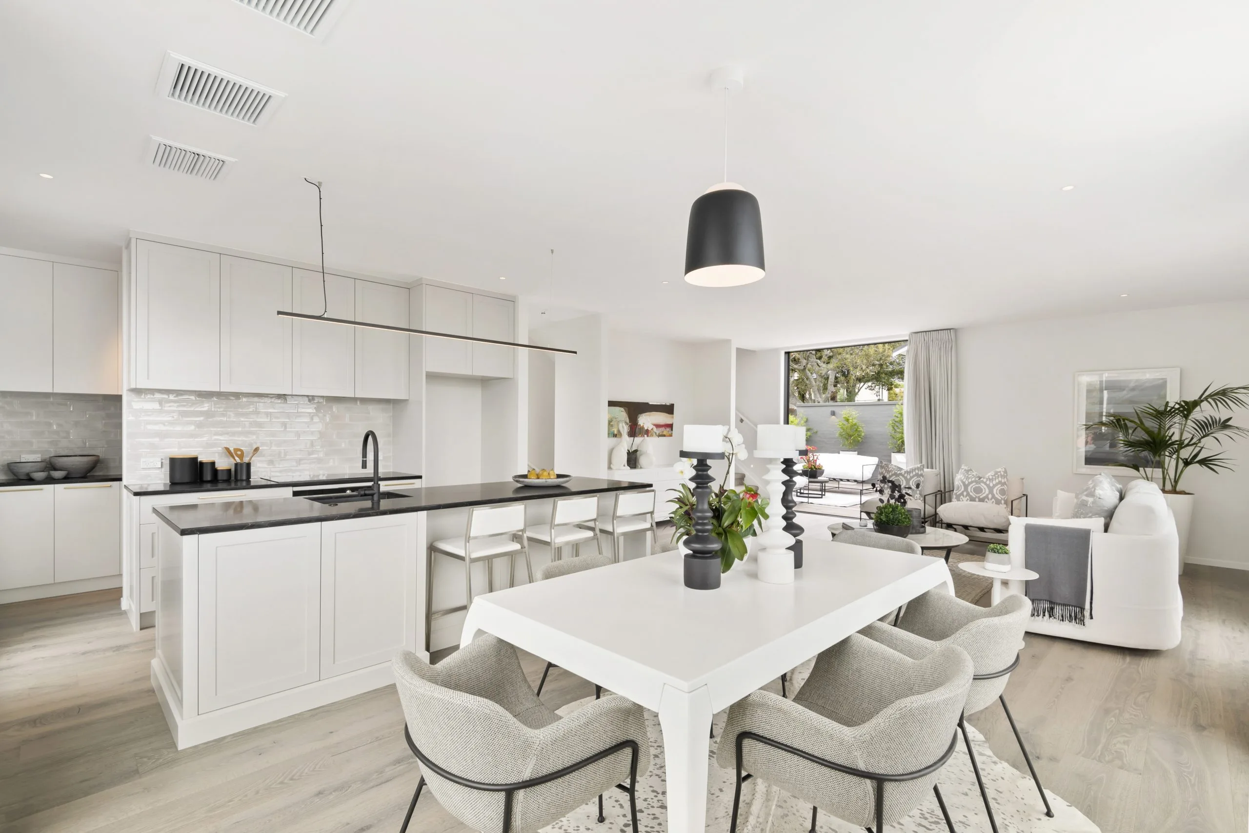 Curran – open-plan kitchen and dining area with a black pendant light over the island