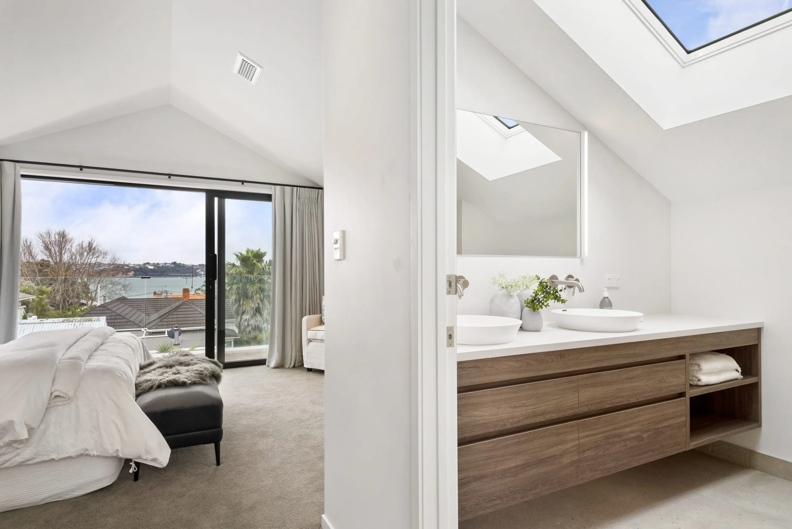 Curran – bedroom opening to an ensuite with skylights and a floating timber vanity