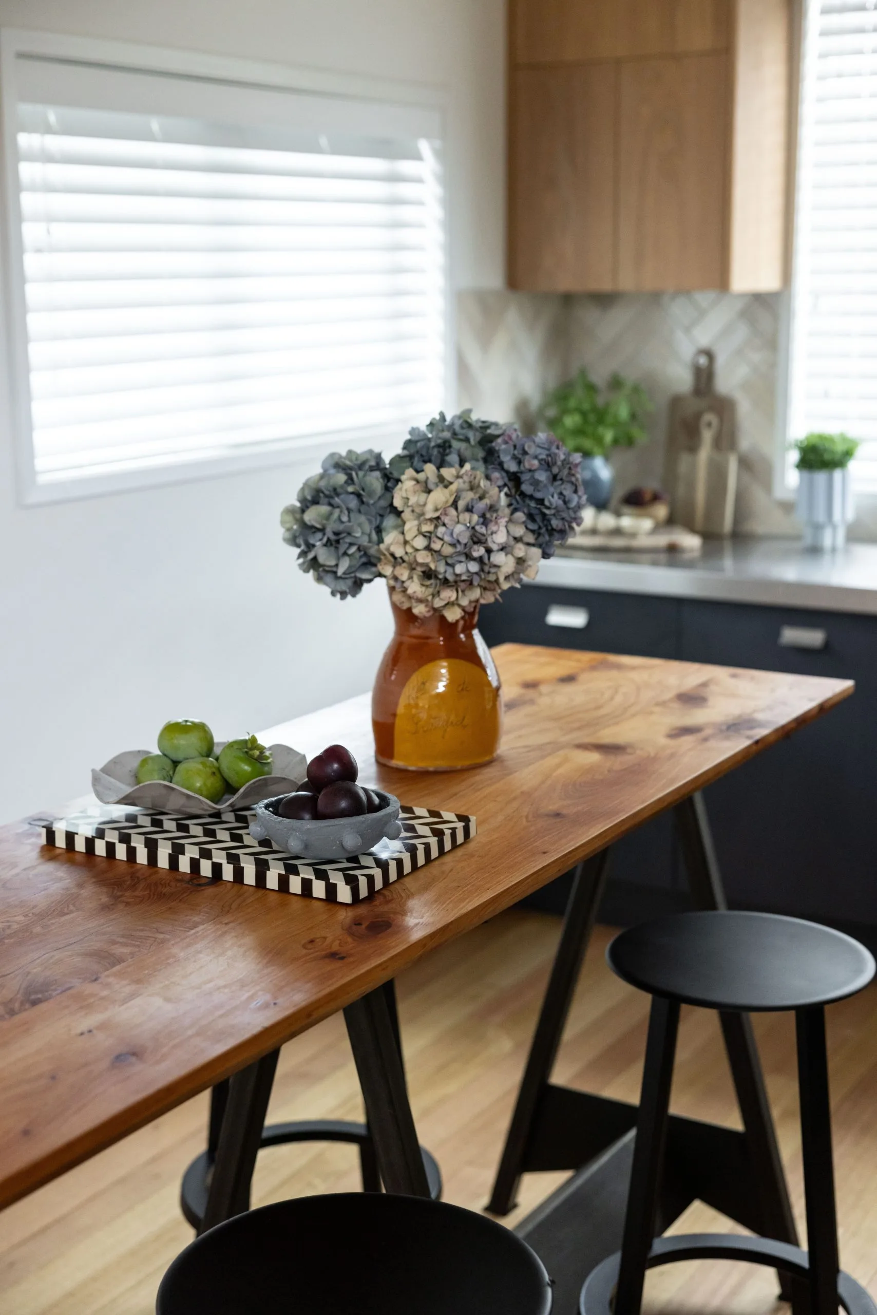 Deep Creek – kitchen island detail with dried hydrangeas, apples and plums on a striped board