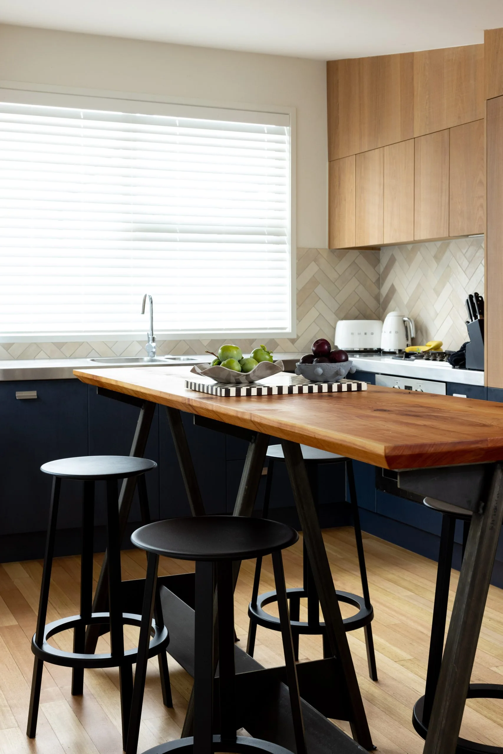Deep Creek – kitchen with herringbone tile splashback, timber island and Smeg appliances