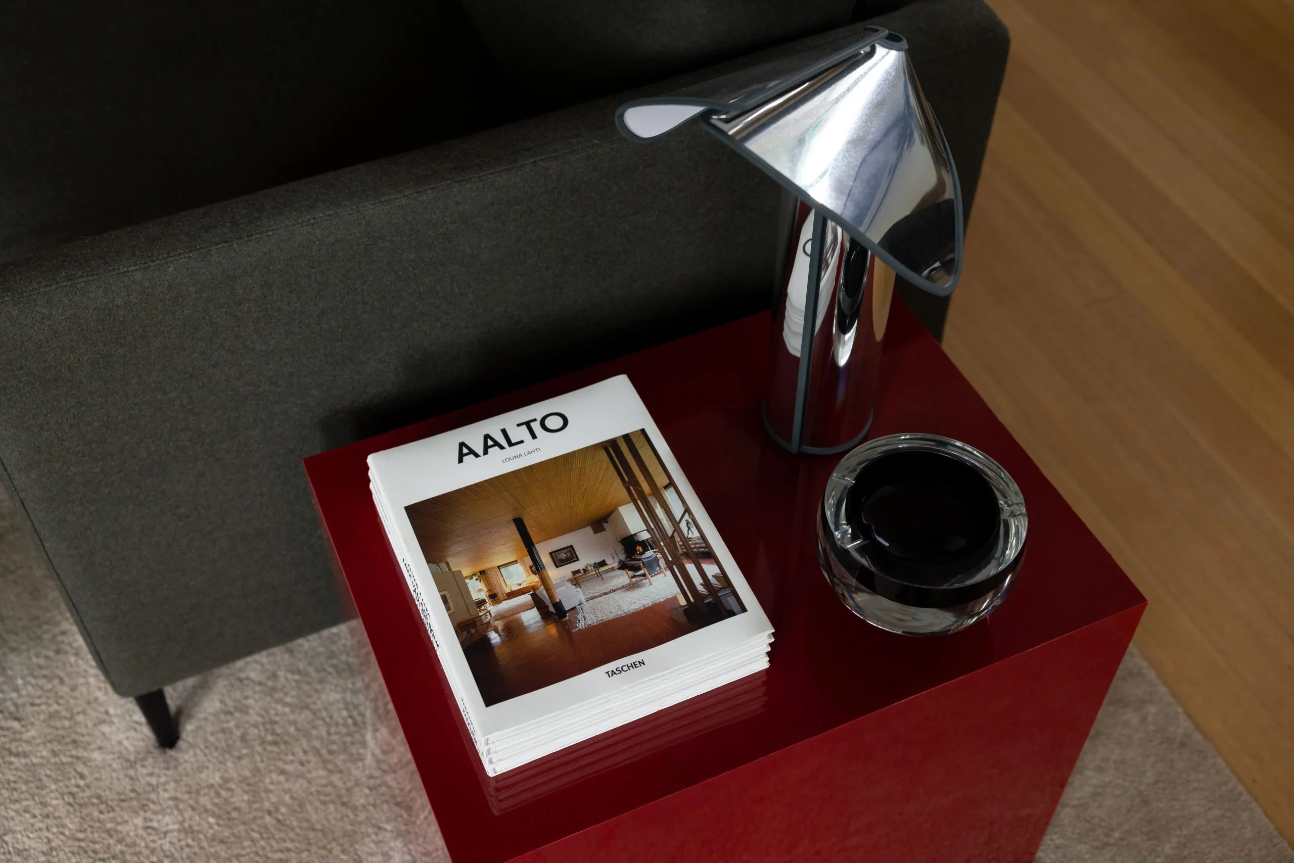 Deep Creek – bookshelf styled with ceramics and books, black leather lounge chair alongside