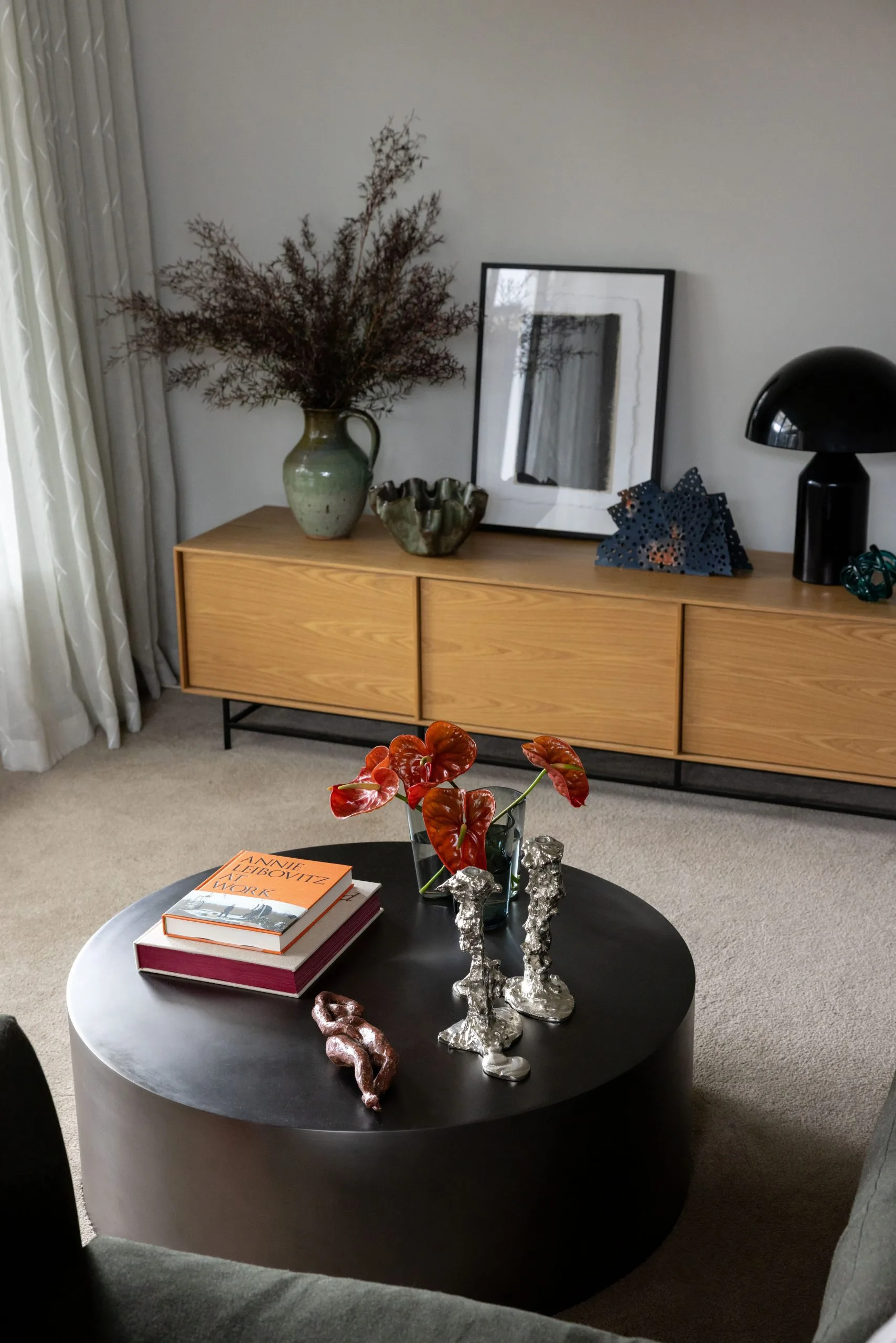 Deep Creek – coffee table styled with anthurium flowers, books and sculptural ornaments