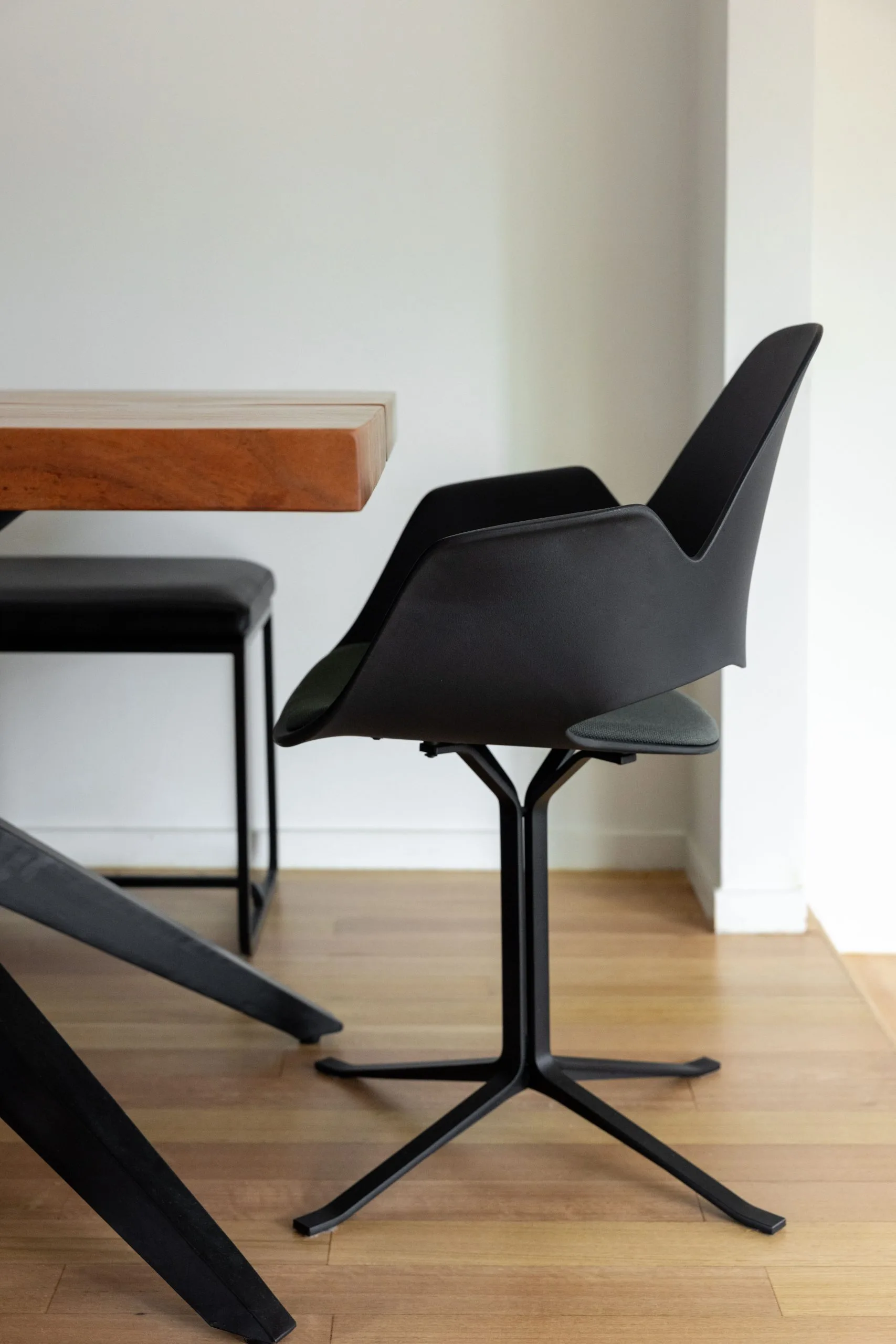 Deep Creek – detail of a black dining chair beside the timber table