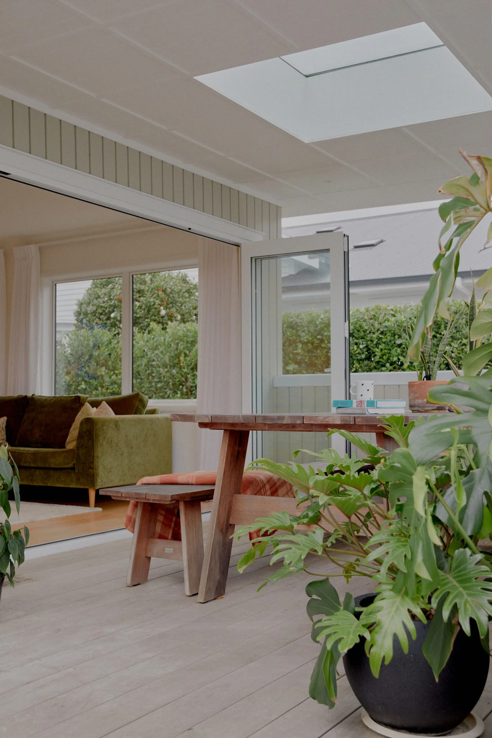 Oakfield – covered outdoor dining deck with skylight, opening to the living room